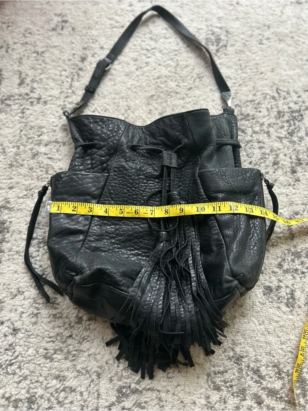 vintage Kooba hobo bag, drawstring closure, fringe tassels, exterior pockets.